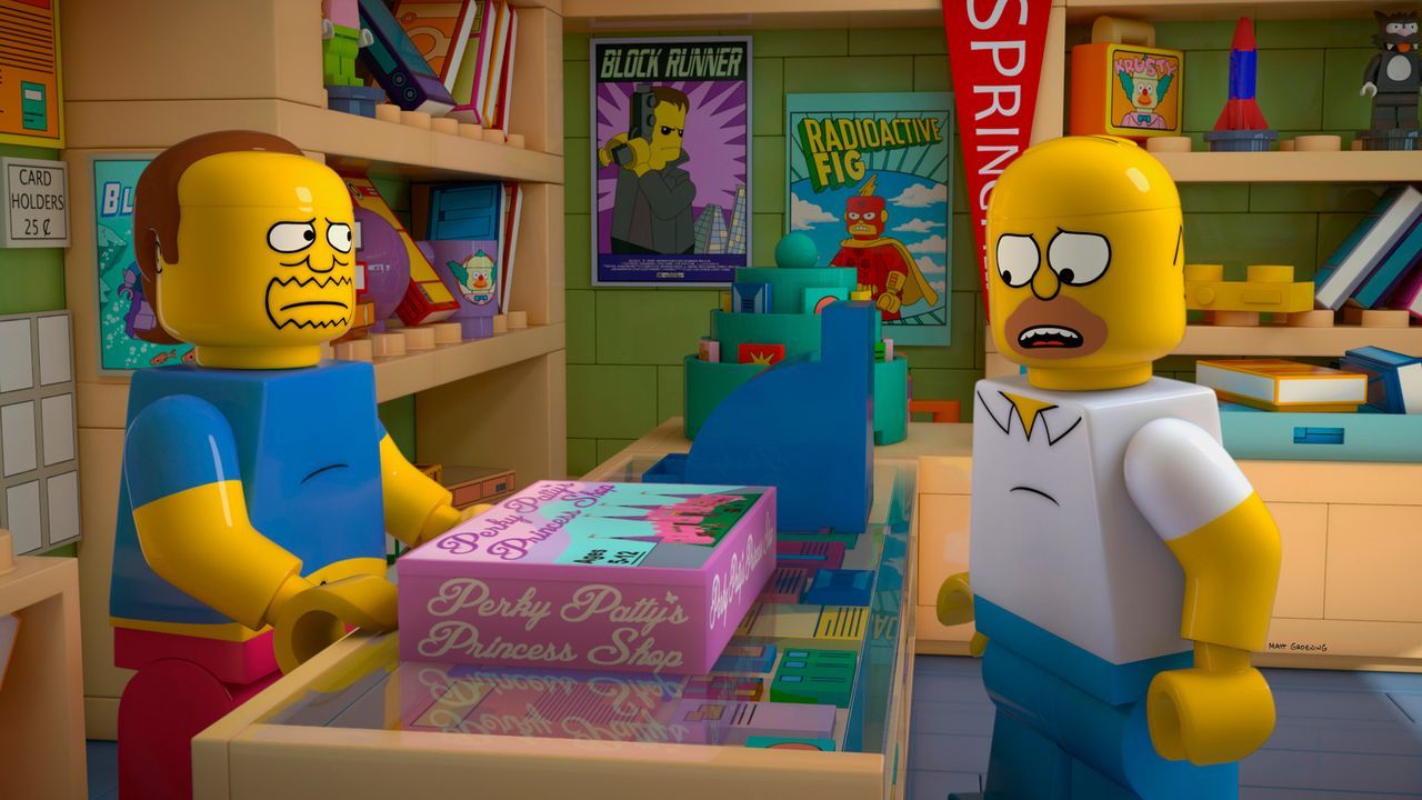 Als Lego-Homer (r.) im Laden des Comicverkäufers (l.) ein Spiel für seine Tochter Lisa kauft, quälen ihn seltsame Visionen: Immer wieder hat er das... - Bildquelle: 2013 Twentieth Century Fox Film Corporation. All rights reserved.