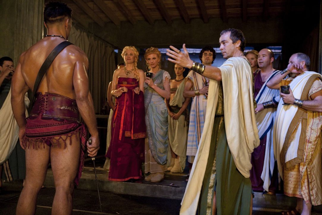 Stellt stolz seine besten Kämpfer vor und beeindruckt vor allem die weiblichen Gäste damit: Batiatus (John Hannah, r.) ... - Bildquelle: 2010 Starz Entertainment, LLC